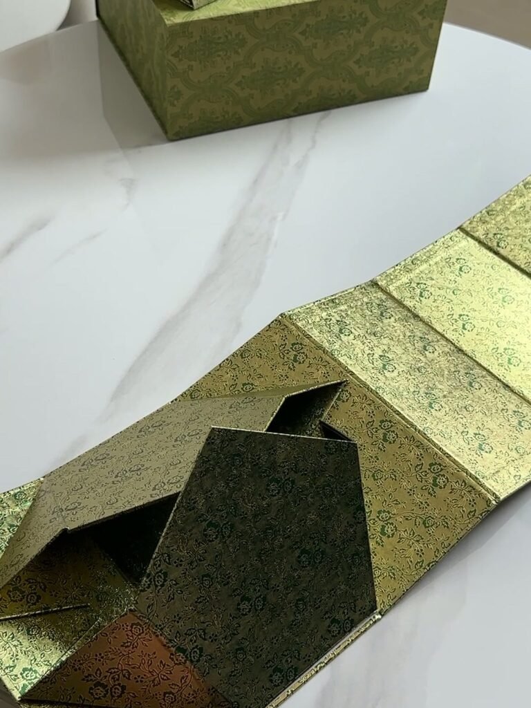 Green collapsible rigid box, one assembled and one folding flat