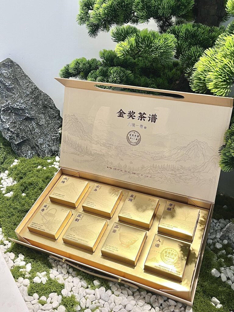 Kraft-look gift box opened to show a gold compartment tray